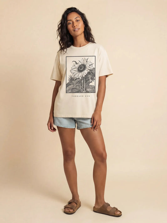 Women's Sunflower Sorona Eco Tee from Threads 626, featuring a sunflower graphic on a casual t-shirt, shown on a white background.