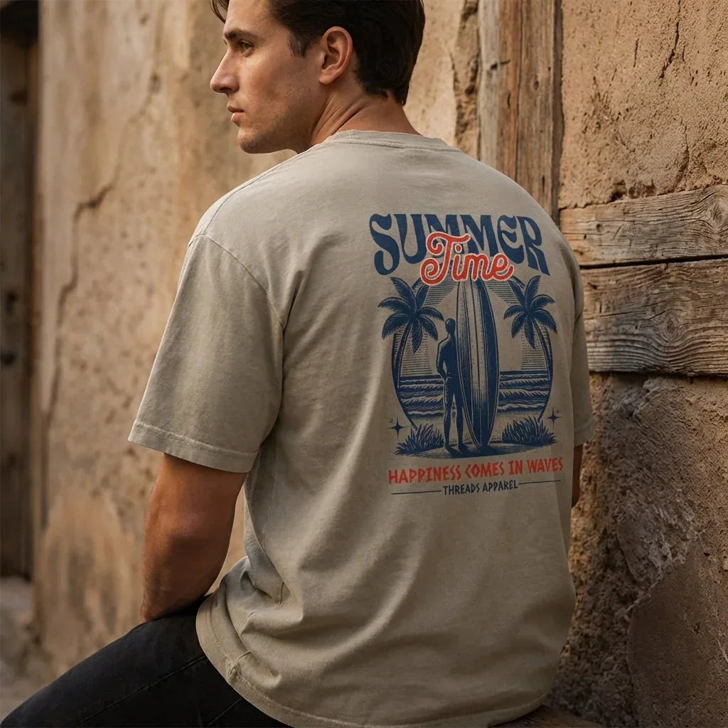 Men's Happiness Comes In Waves enzyme-washed cotton t-shirt by Threads 626, styled on a model, side view showing relaxed fit and fabric texture.